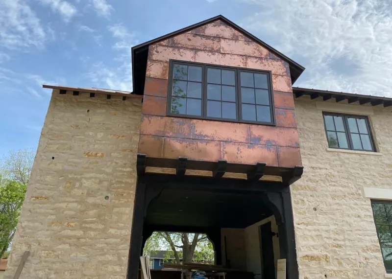 Copper metal panel facade on a stone building for Skylight Installation in Golden Hills